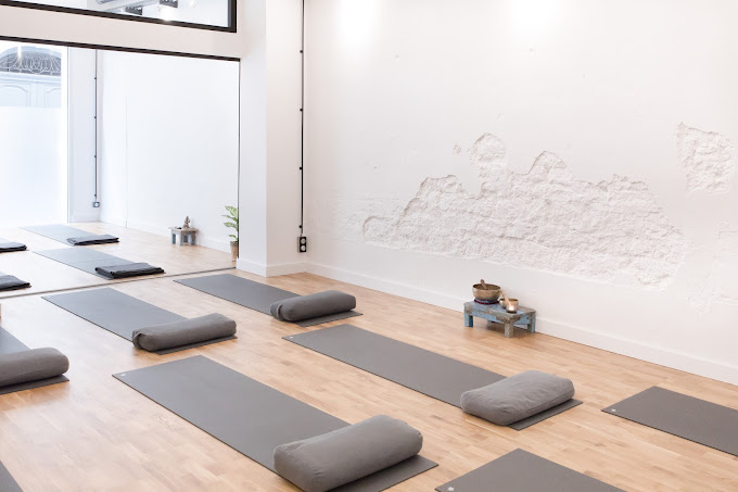 Clean Yoga studio with white exposed brick wall and natural light 